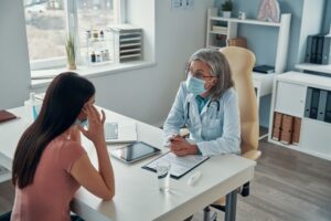 a doctor educating a patient on the importance of health insurance